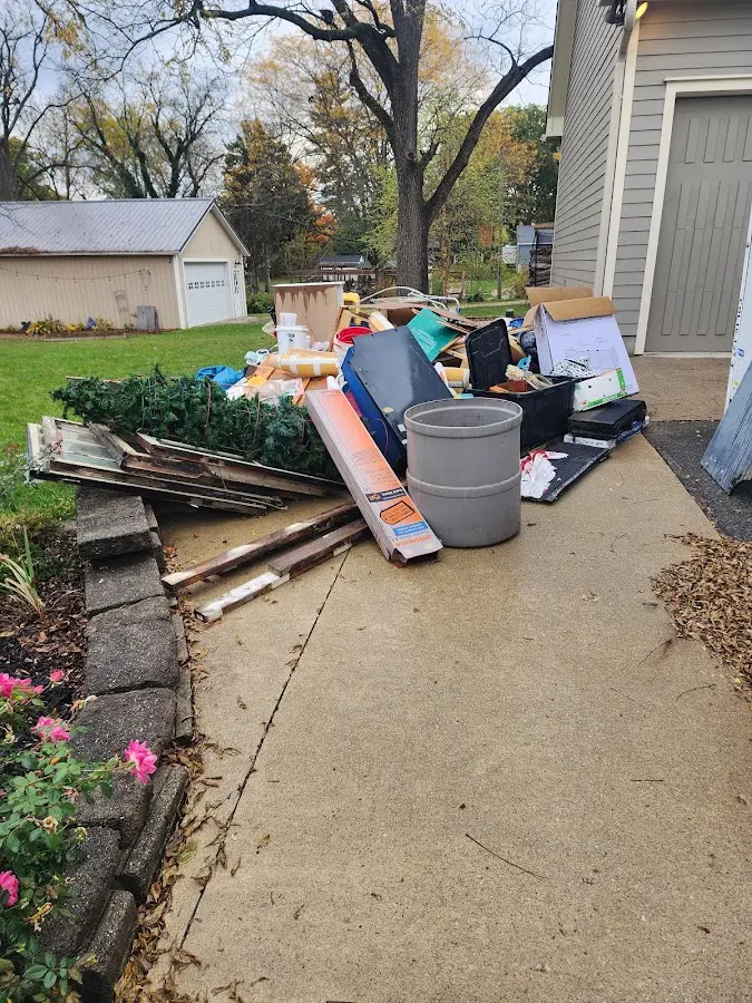 Dumpster being loaded with debris for Estate Cleanout Dumpster Rental in Thief River Falls
